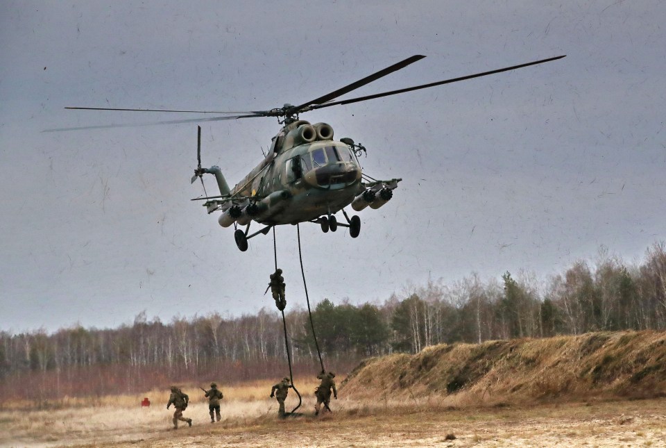 Soldiers fast-rope from a helicopter during an exhibition performance held as part of the visit of the members of the Kyiv Association of Military Attaches and International Organisations