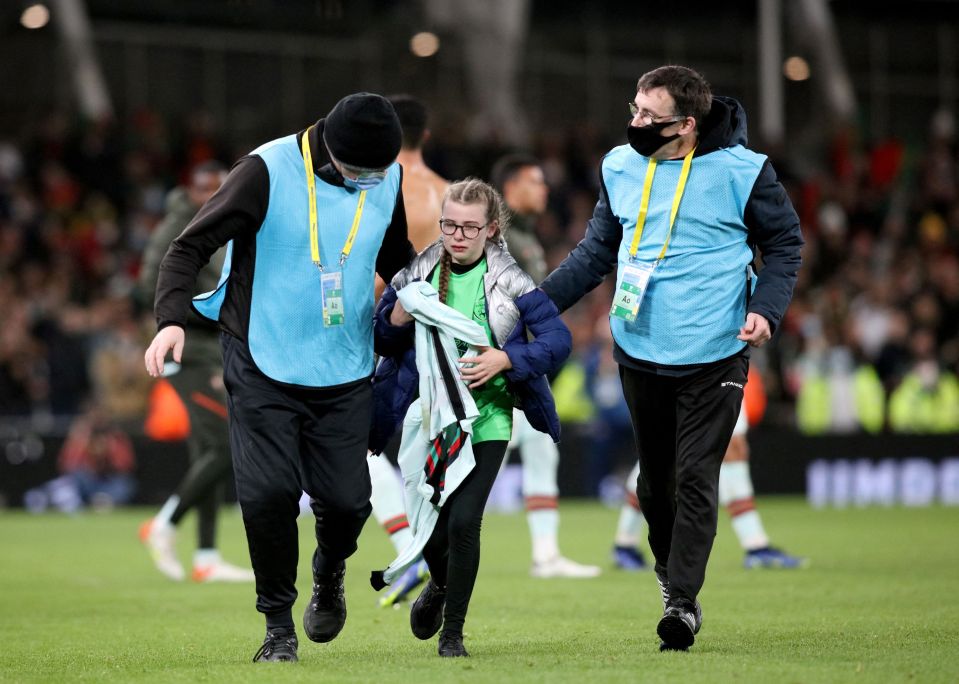 The tears of joy appear to flow as she leaves the pitch with her prized possession