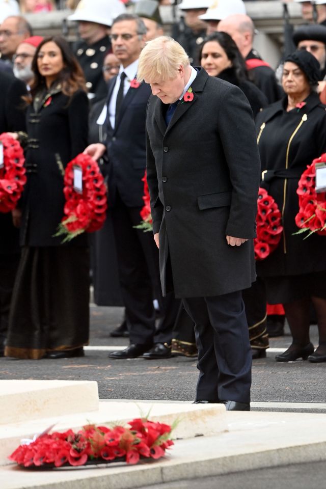 Boris bows his head as he lays a wreath at the service