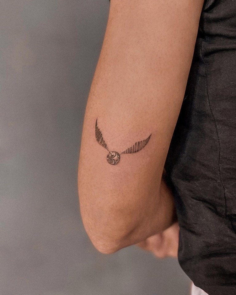 Messi's wife has a golden snitch - an item used in the fictional sport of Quidditch that features in the series - tattooed on the back of her left arm.