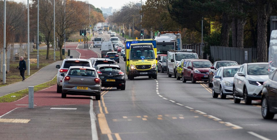 Cars can be seen pulling out into the spacious cycle lanes to steer clear of emergency vehicles