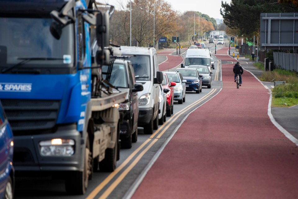 Busy traffic files into a one-lane creating queues