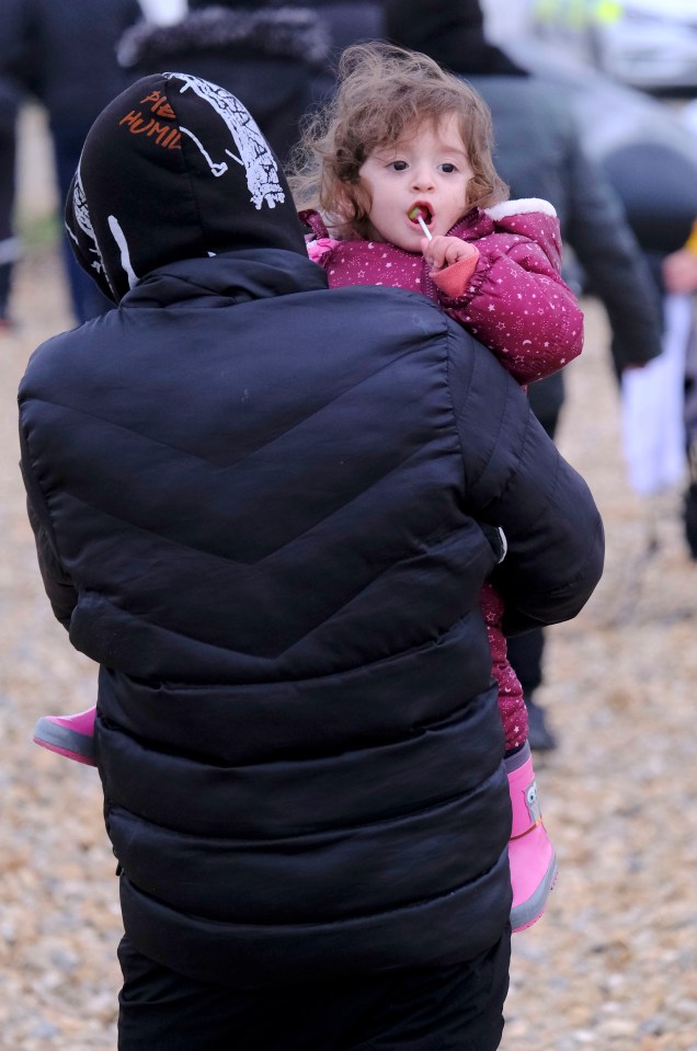 A lollipop for one girl as other children sit in boat