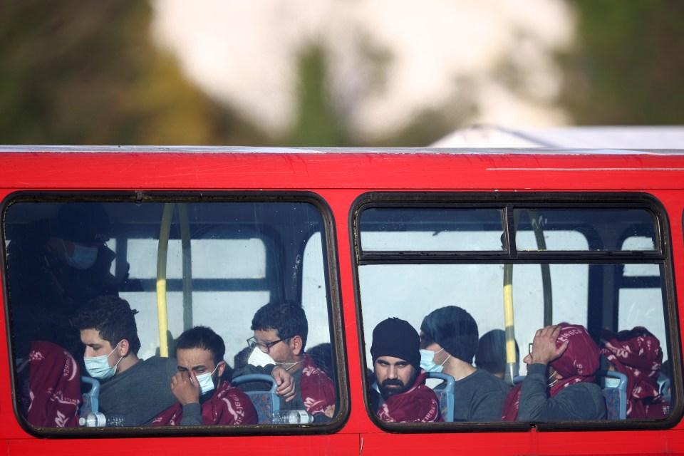 At least 50 asylum seekers were brought into Dover huddled on RNLI lifeboats before being moved onto waiting buses