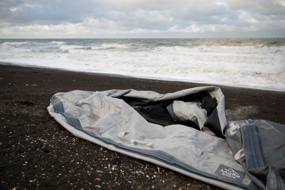 A damaged inflatable dinghy is seen on Loon Beach, the day after 27 migrants died