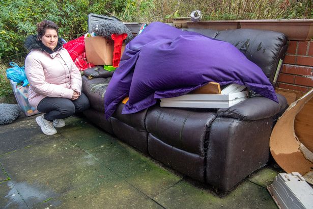 A pregnant mum and her family sleep on a sofa in their living room because they're worried about falling ill in their mouldy flat