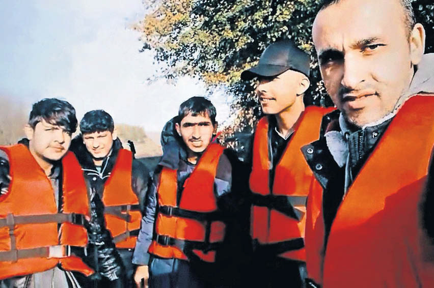 Shakar Ali, 25, (second from left) and Harem Pirot, 23 (centre) with a group of migrants who have not been seen since a dinghy capsized in the Channel on Wednesday