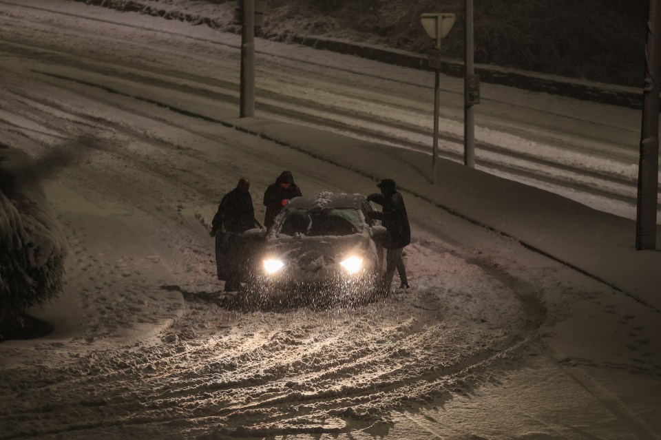 Friendly locals in Barnsley helped push a car stranded in snow