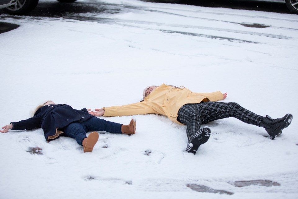 Poppy, 9, And Nancy, 2, of Wakefield, West Yorkshire make the most of the snow