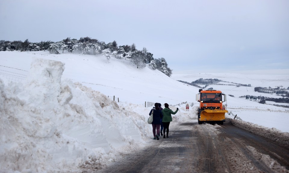 A snow plough clears the A53 road between Leek and Buxton after Storm Arwen, Buxton, Derbyshire