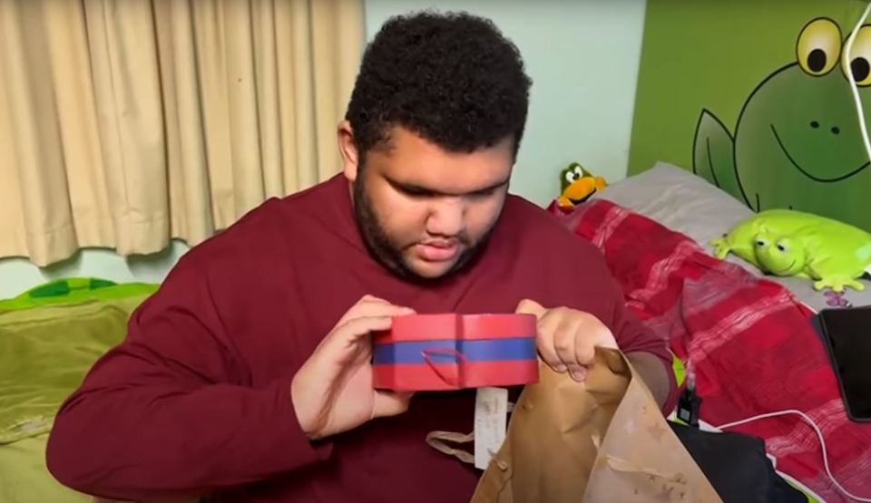 The teen was overjoyed with his Christmas-themed gifts