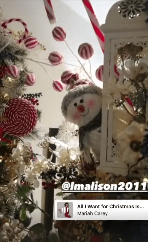 A snowman peeked out from the tree