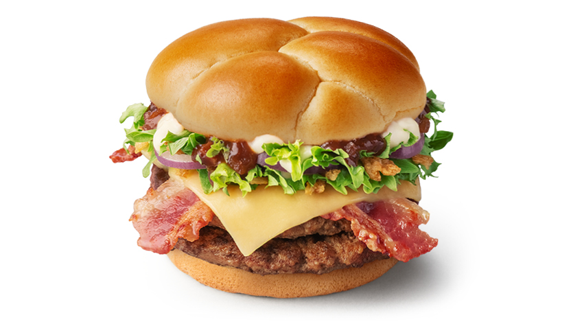 The festive stack features two juicy burger patties and is topped with bacon