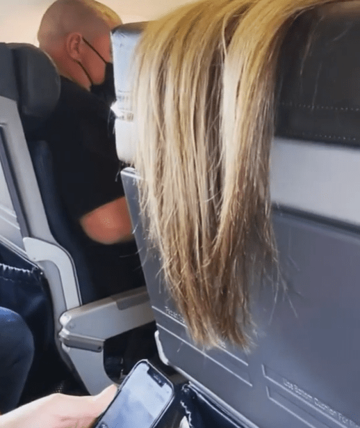 A passeneger was slammed for putting her hair over the back of her seat during a flight