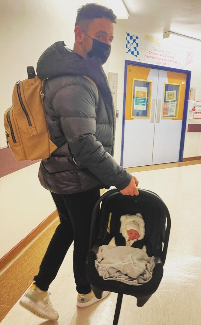 Richie leaves hospital with his baby daughter late last year