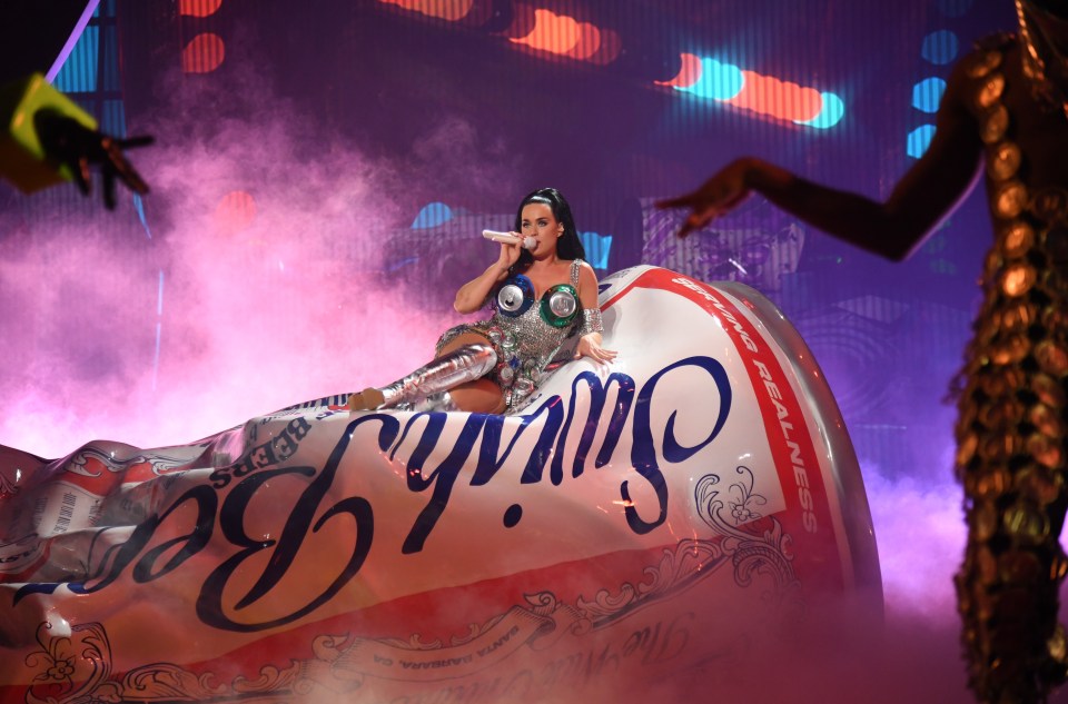 Katy reclines on a giant can of beer, drinking up the attention from 5,000 fans