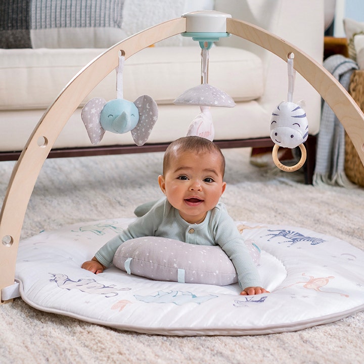 Aden & Anais' baby activity gym features detachable toys and a tummy time pillow