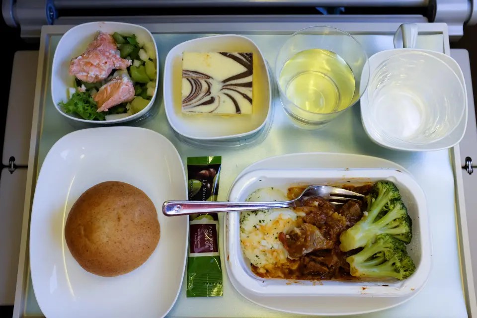 Your sense of smell is worse when flying, so the food appears to have less taste