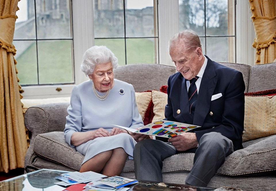 The Queen wears the jewellery as the pair admire cards on their 73rd anniversary in 2020