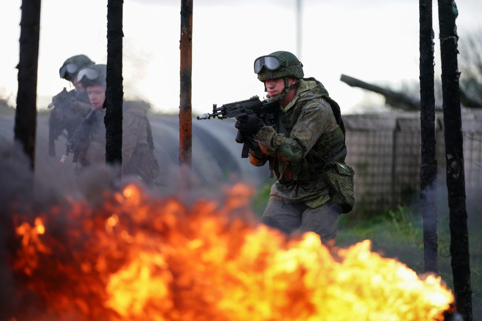 Marines of the Baltic Fleet forces of the Russian Navy train in the zone of obstacles during military exercises at the Khmelevka firing ground amid rumours of growing tensions with Ukraine