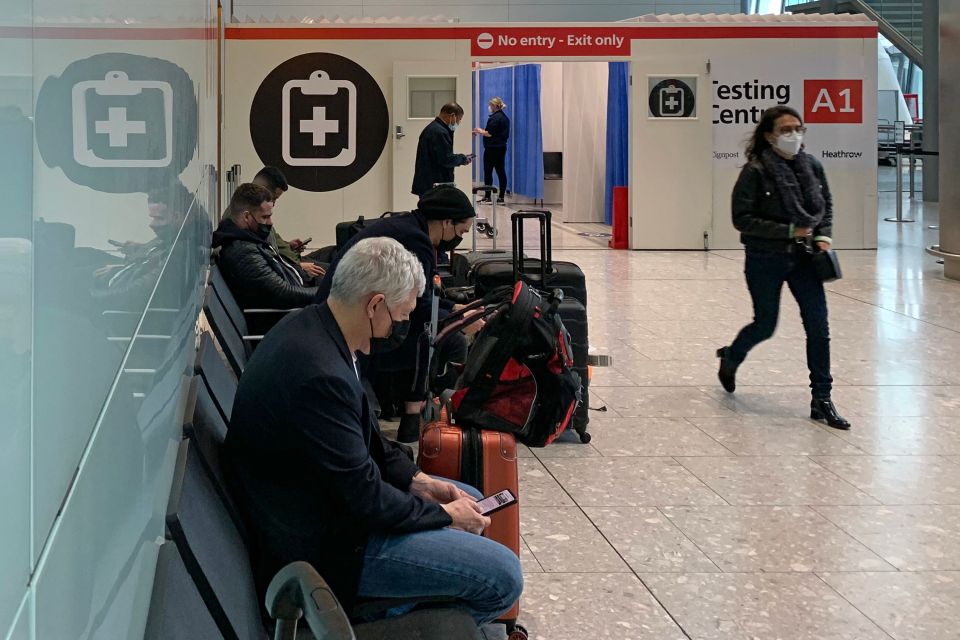 People wait outside the Covid-19 testing facility at Heathrow's Terminal 5