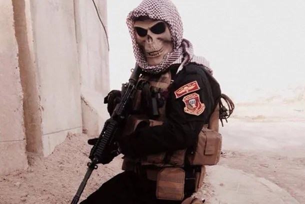 Golden Division troops don skull face-masks, skull balaclavas, or skull insignias