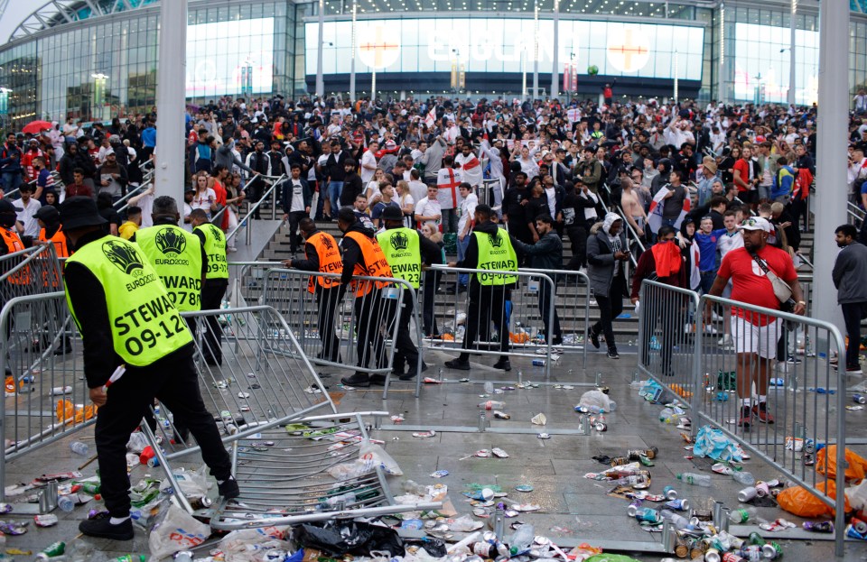 Stewards replace barricades after they were knocked over by supporters outside Wembley Stadium in London, during the Euro 2020 final match between England and Italy, on July 11, 2021