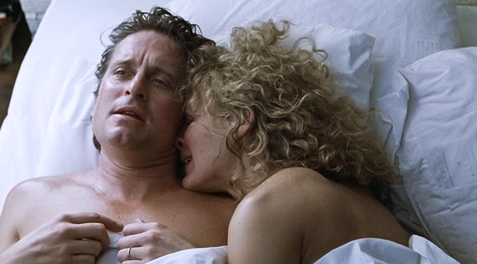 Alex Forest, played by Glenn Close snuggles up to Dan Gallagher, played by Michael Douglas in the original movie version of Fatal Attraction