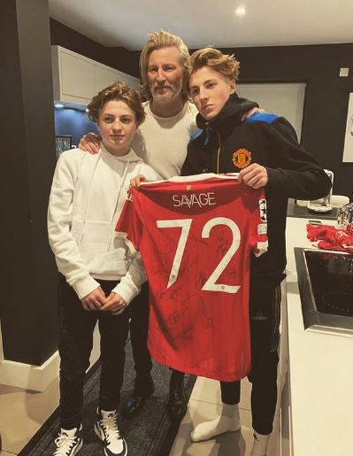 Robbie Savage poses with sons Freddie and Charlie after his Man Utd debut