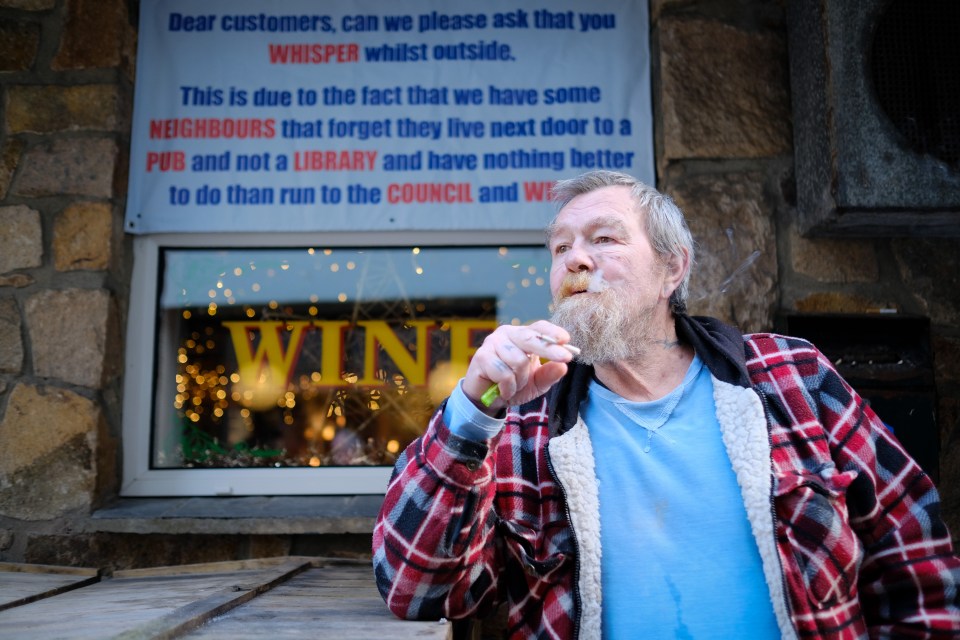 Regular Taff Waite enjoys a cigarette outside The Three Ferrets pub in St Ives, Cornwall