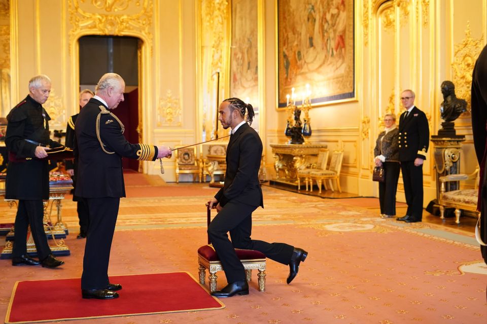 Sir Lewis Hamilton is knighted by Prince Charles at Windsor Castle as his mum watches on