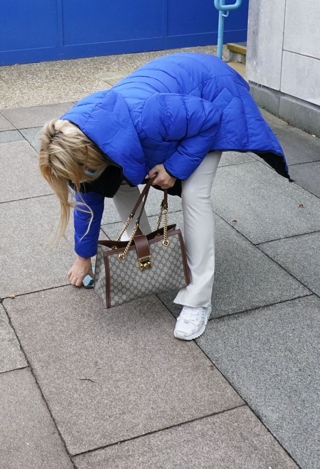 She was pictured bending down to pick it up from the ground