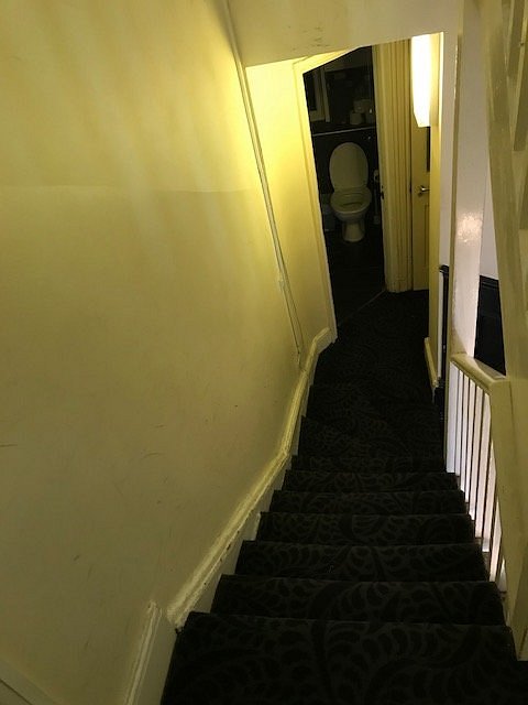 Stairs leading down to a shared bathroom