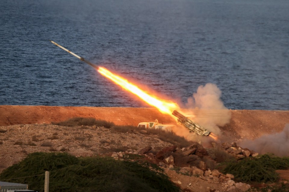 An image grab of footage obtained from Iranian State TV shows the Islamic Revolutionary Guard Corps (IRGC) firing missiles