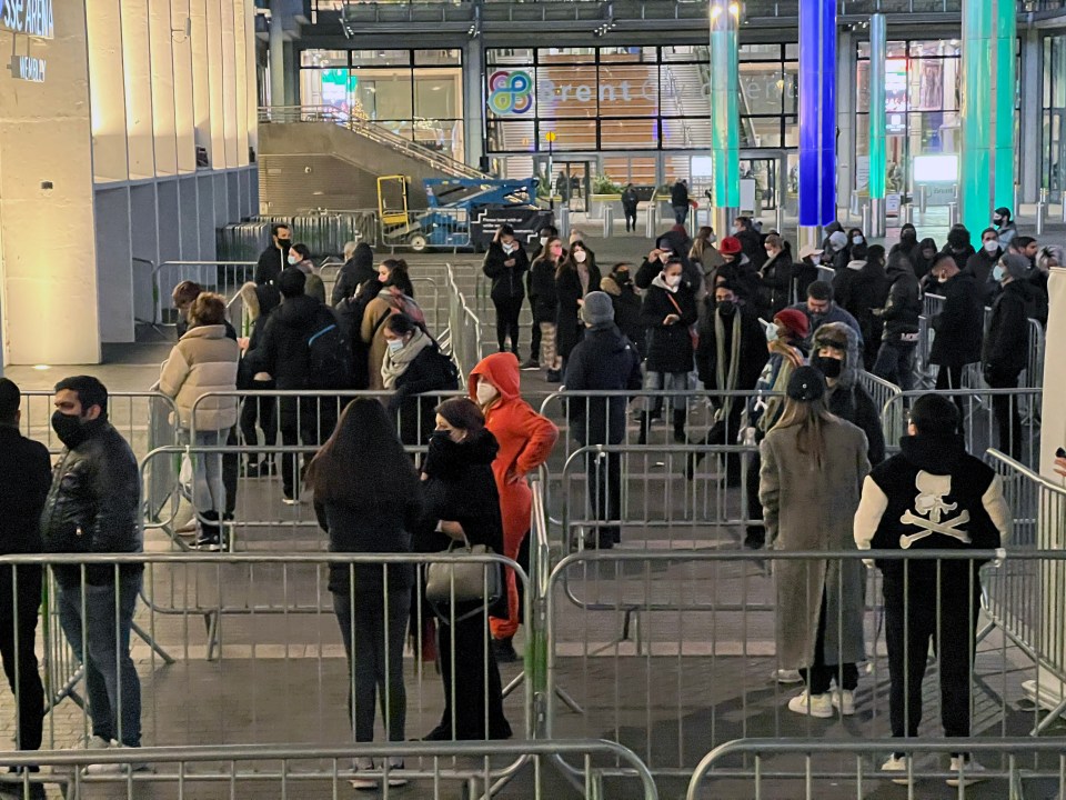 Members of the public queue for their jabs outside the arena