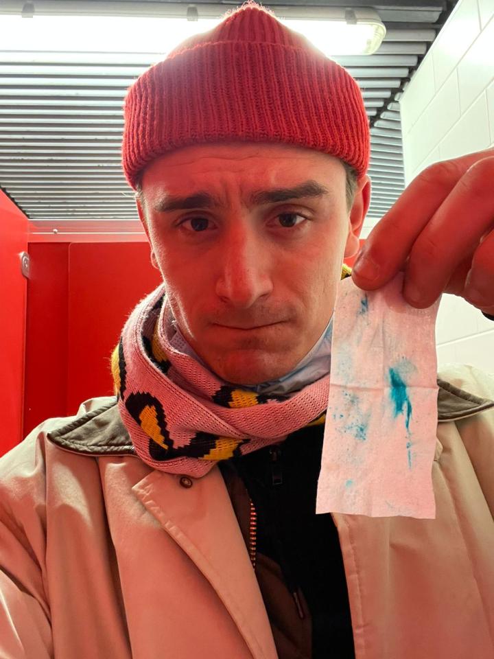 Sun reporter Liam Coleman holding up a cocaine detection wipe at an Arsenal game at Emirates stadium