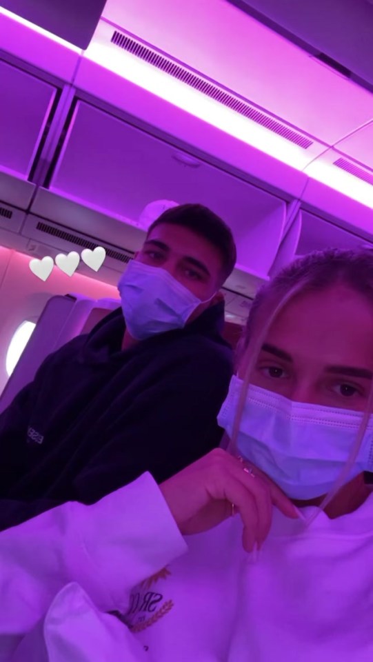 The couple wore their mandatory face masks on board the fight