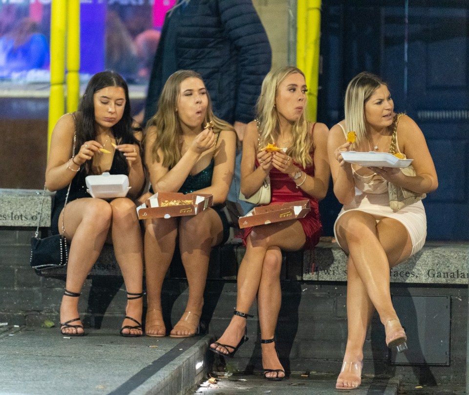 A group of girls mop up the booze with a late night snack