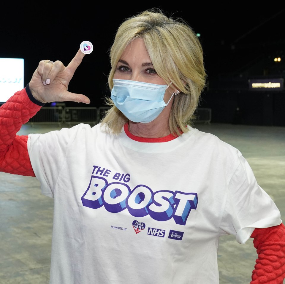 Anthea Turner holds up her booster jab sticker after attending out event