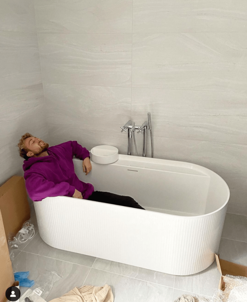 Sam Thompson relaxes in his new bathtub