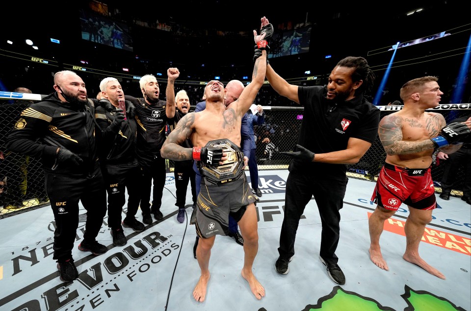 A delighted Charles Oliveira celebrates his emphatic title defence