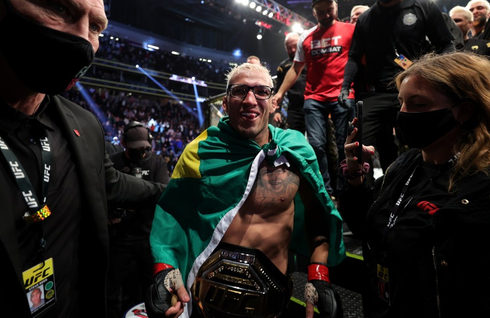 Charles Oliveira celebrates his stunning victory over The Diamond