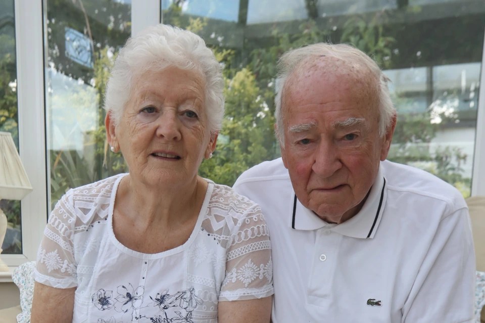 a man and woman are posing for a picture and the man has a lacoste shirt on