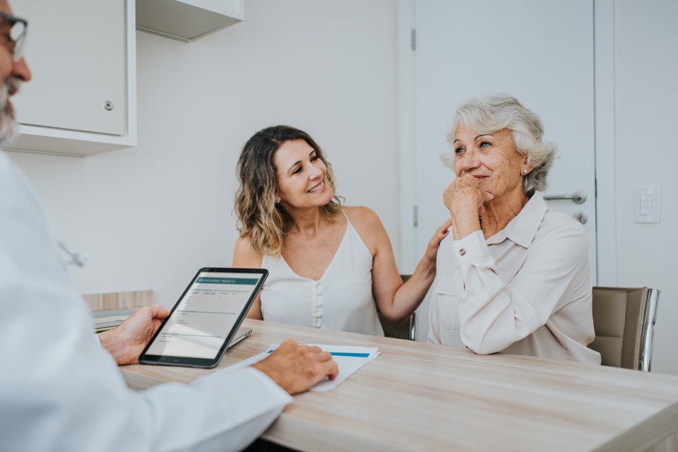 Doctor consulting with a senior woman and her daughter.