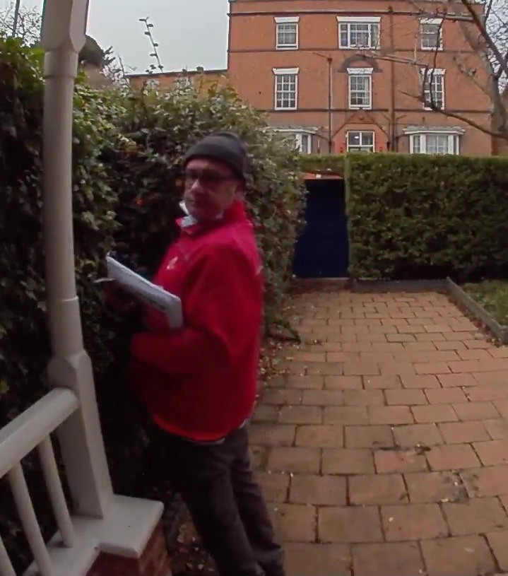 A Royal Mail worker was seen weeing in a bush in front of a family's front door