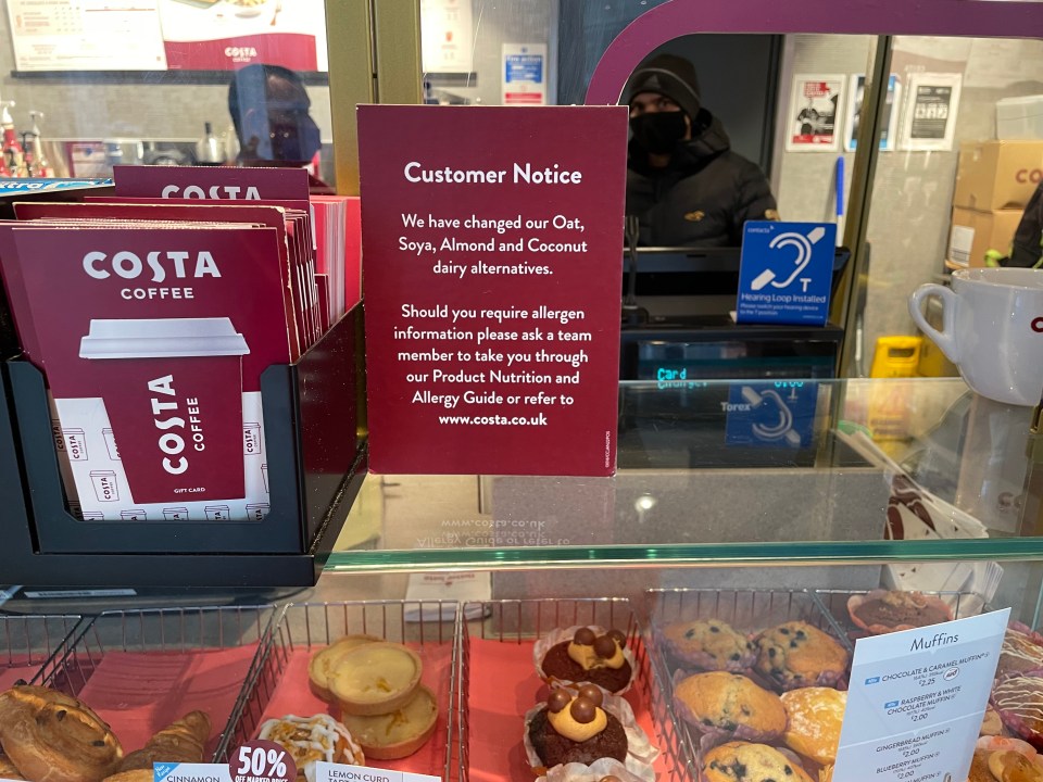 Signs informing customers of a change in dairy milk alternatives are on display in stores