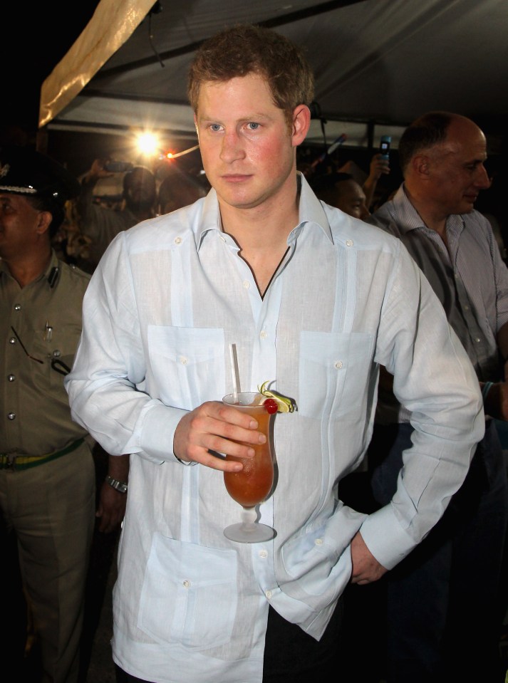 Harry enjoys a drink as he attends a Jubilee Block Party in Belize in 2012