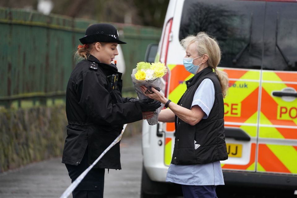 Flowers are brought to Ashburton Park, Croydon, South London after a 15-year-old boy was stabbed to death on Thursday