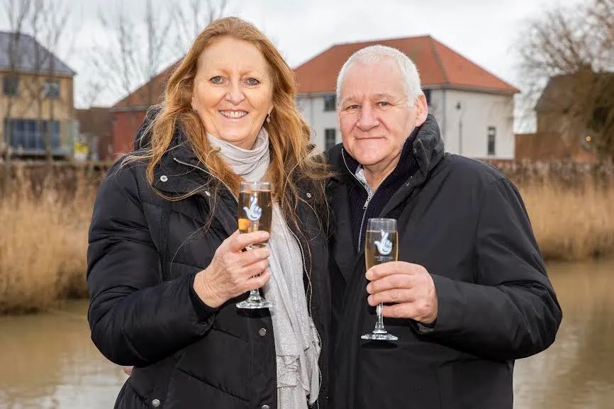 The couple celebrating their prize after shielding for almost two years