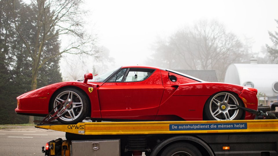 The bright red Enzo sports car, one of only 400 made, had two wheels ripped off and may be irreparable